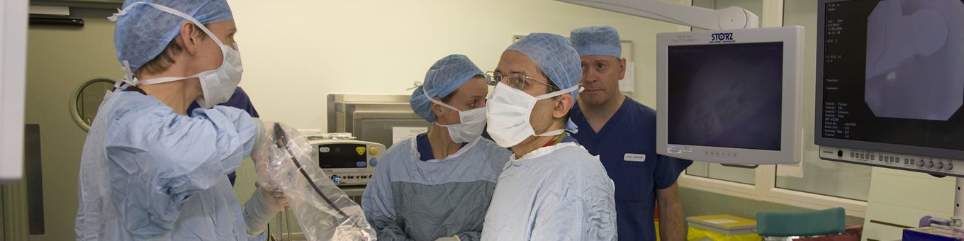 doctors in a surgical setting wearing masks and scrubs