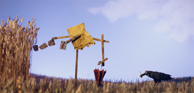 A still image from the film Au revoir Balthazar, showing a corn field from a low angle with unusual scarecrows in the foreground