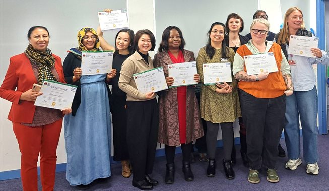 A group of people standing and holding certificates