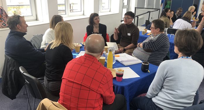 A group of people sitting around a table talking