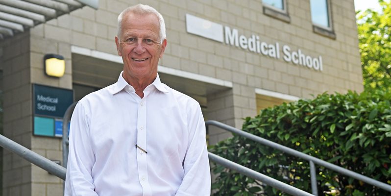 Malcolm Reed standing outside the medical school teaching building