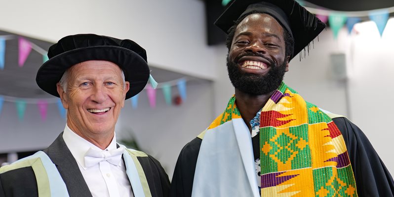 Malcolm Reed and a student in graduation attire at the 2023 BSMS graduation