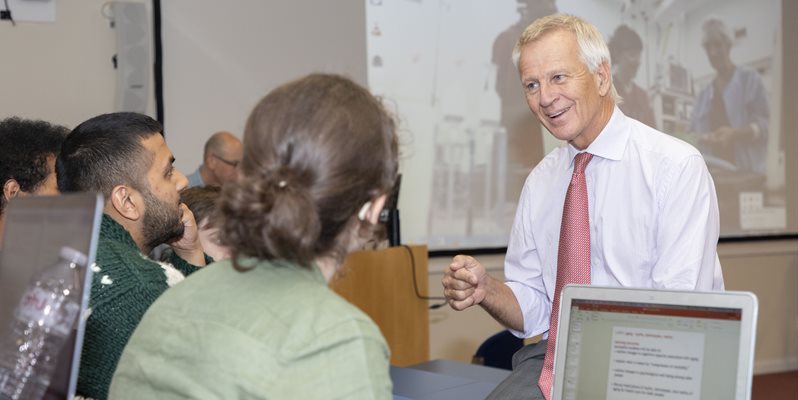 Malcolm Reed in the lecture theatre talking with students