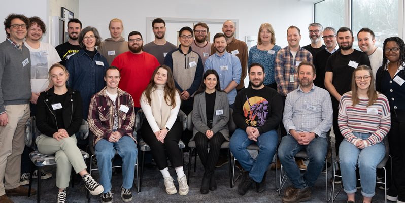 A group of people who form the RNA group in a team photo