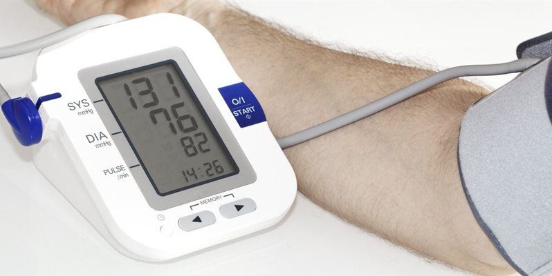 A close up of a monitor showing hypertension being checked on a patient