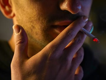 A close up of someone smoking a cigarette