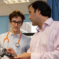 GP explains medical instrument to student